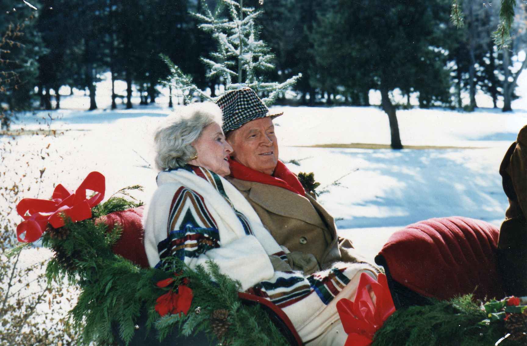 Bob Hope and his wife seated outdoors during a wintertime location shoot